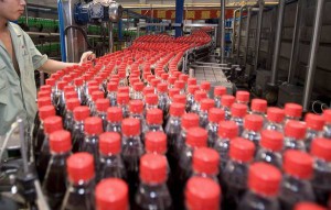 A worker at the Wahaha bottling plant examines bottles of " future cola " in the quality control line at the bottling plant in Hangzhou, Wednesday, 23 August 2006. ANSA/Diego Azubel