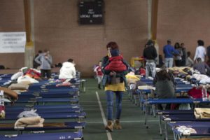 Residents rest in a warehouse where they found a temporary shelter in the town of Camerino, central Italy, 28 October 2016, after a 5.9 earthquake destroyed part of the town. Authorities scrambled to find housing Thursday for thousands of people displaced by a pair of strong earthquakes that struck the same region of central Italy hit by a deadly quake in August. ANSA/MASSIMO PERCOSSI