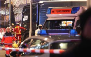 epa05682774 Rescue workers inspect the scene where a truck crashed into a Christmas market, close to the Kaiser Wilhelm memorial church in Berlin, Germany, 19 December 2016. According to the police, several people are reported killed and many injured in what police suspect it was a deliberate attack. EPA/MICHAEL KAPPELER